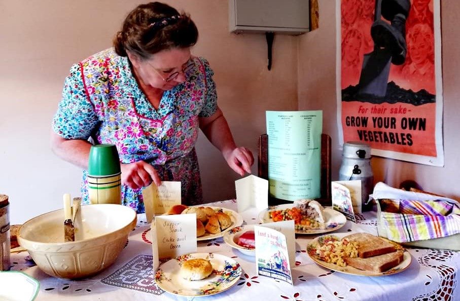A wartime food display with period recipes and a 'Grow Your Own Vegetables' poster