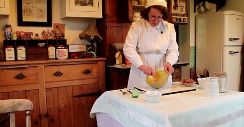 Utility Jude preparing a wartime recipe in a 1940s kitchen